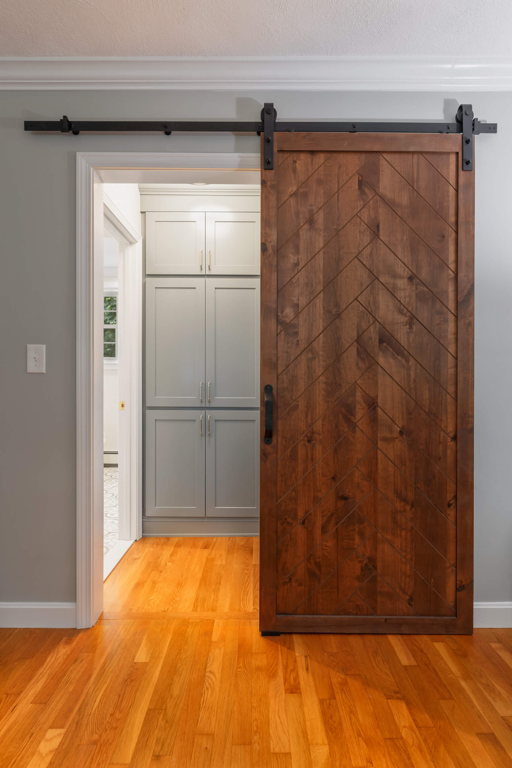 linen and clothing storage between bedroom and bathroom, barn door