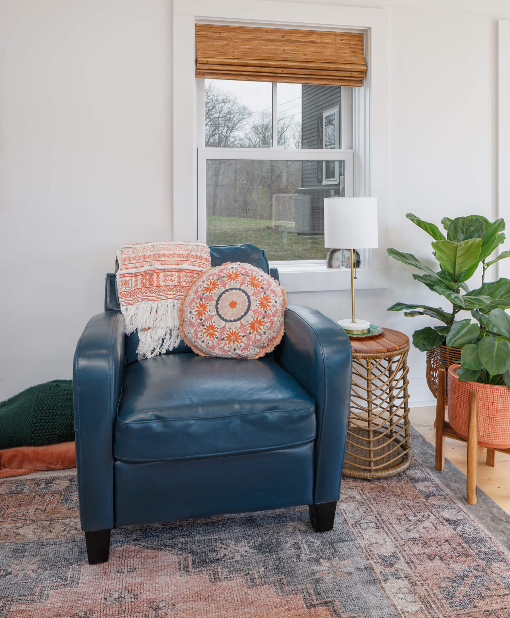 Blue armchair, potted plants, side table with lamp