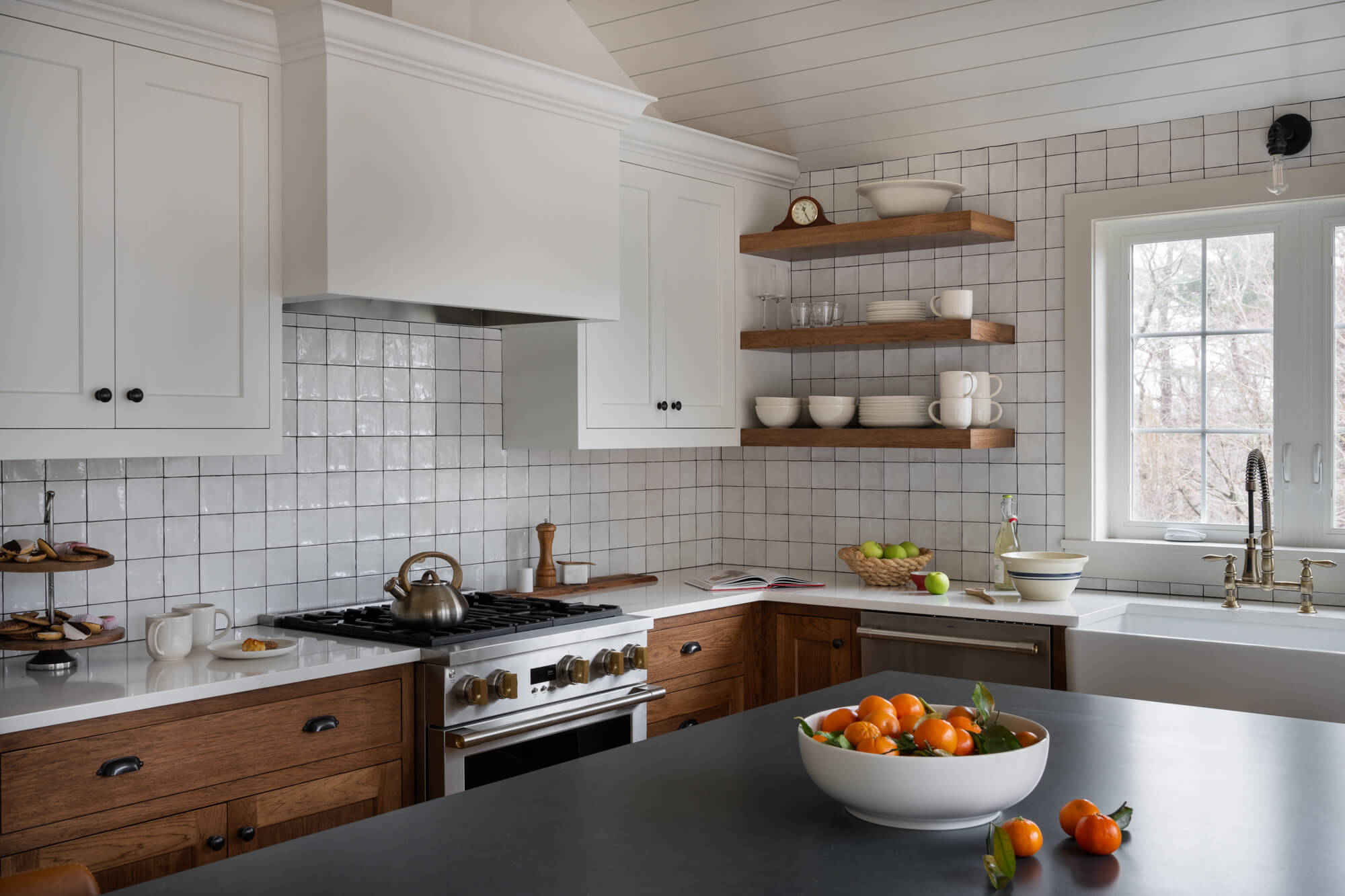 Silestone charcoal soapstone island countertop, white upper cabinetry, natural wood lower cabinetry