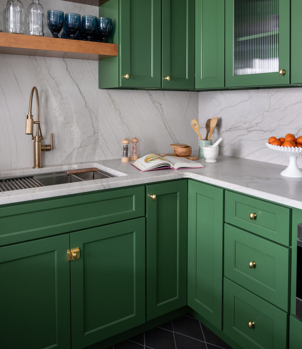 Santorini quartzite counters, green painted cabinetry, open shelving above sink