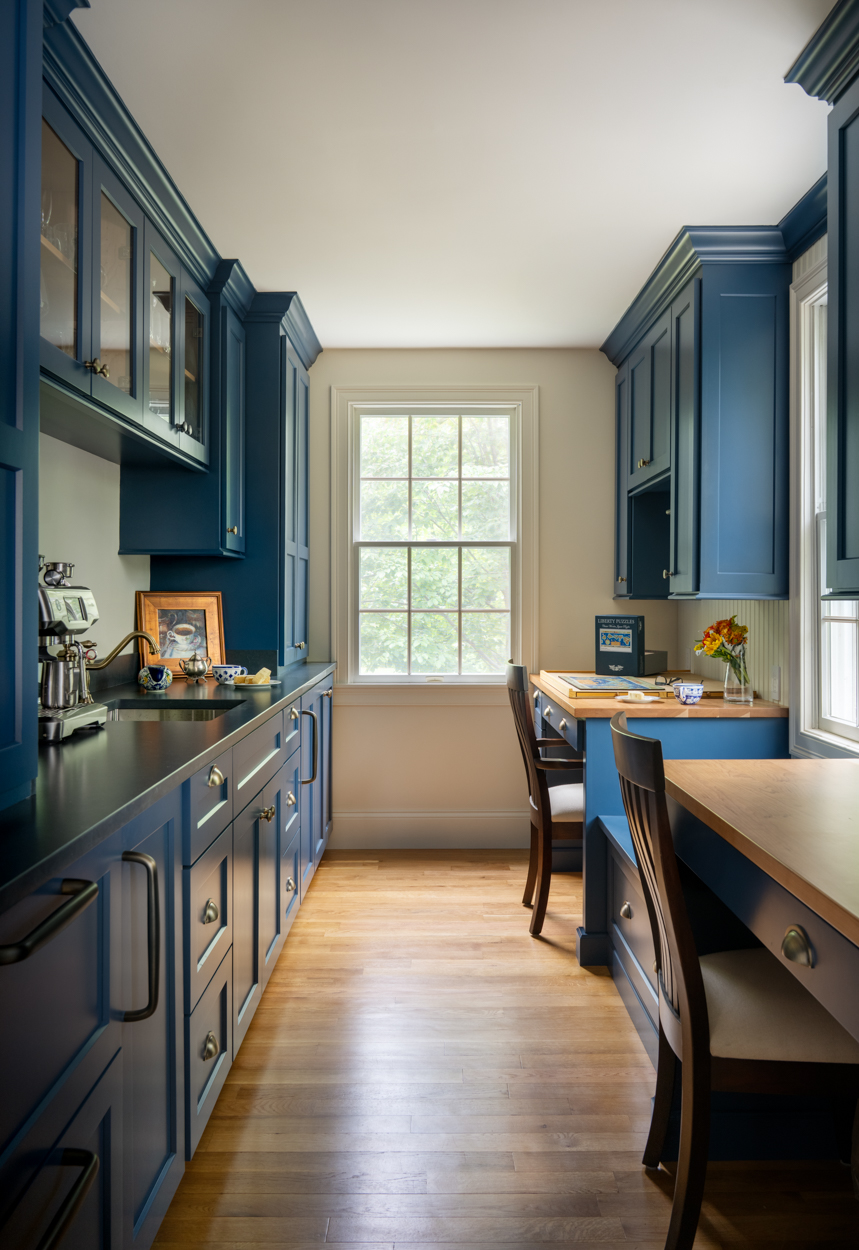 blue cabinetry, butcherblock desk tops, window, black counters
