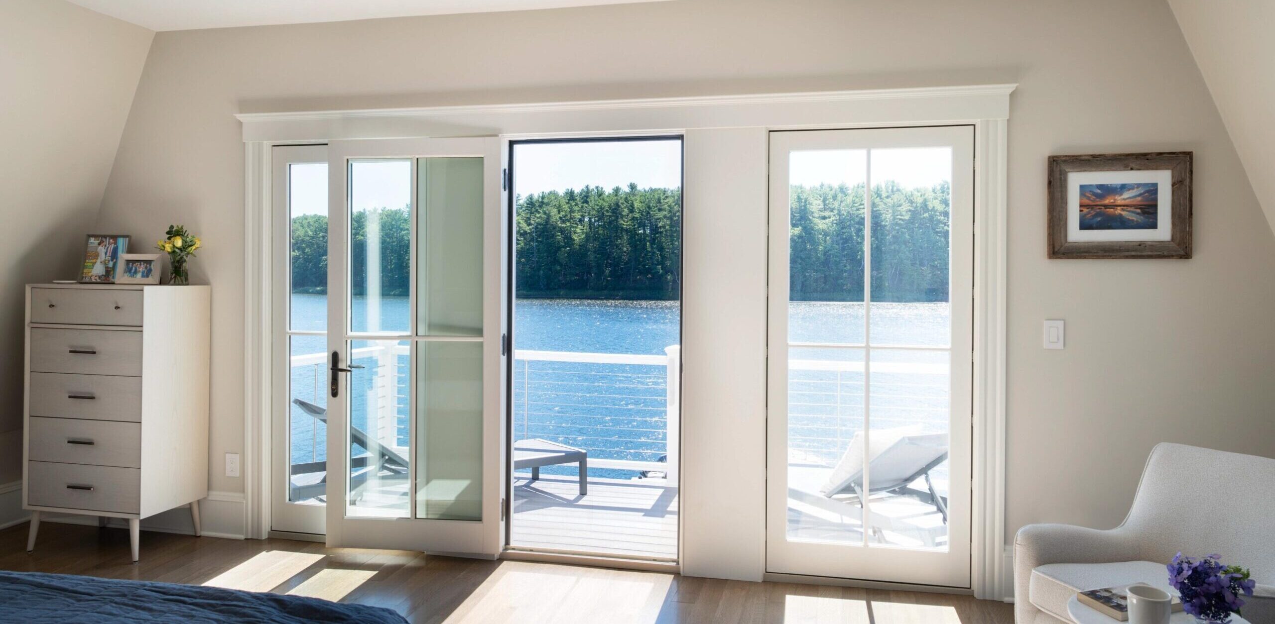 Bedroom with french doors onto a deck overlooking the water