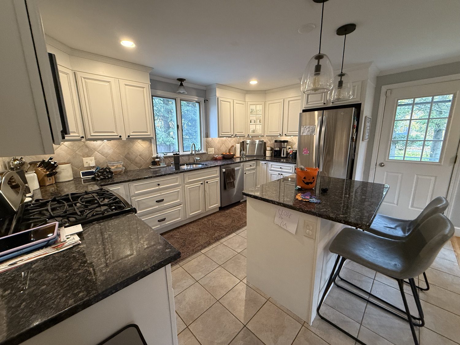Original kitchen with dark granite counters and a small island