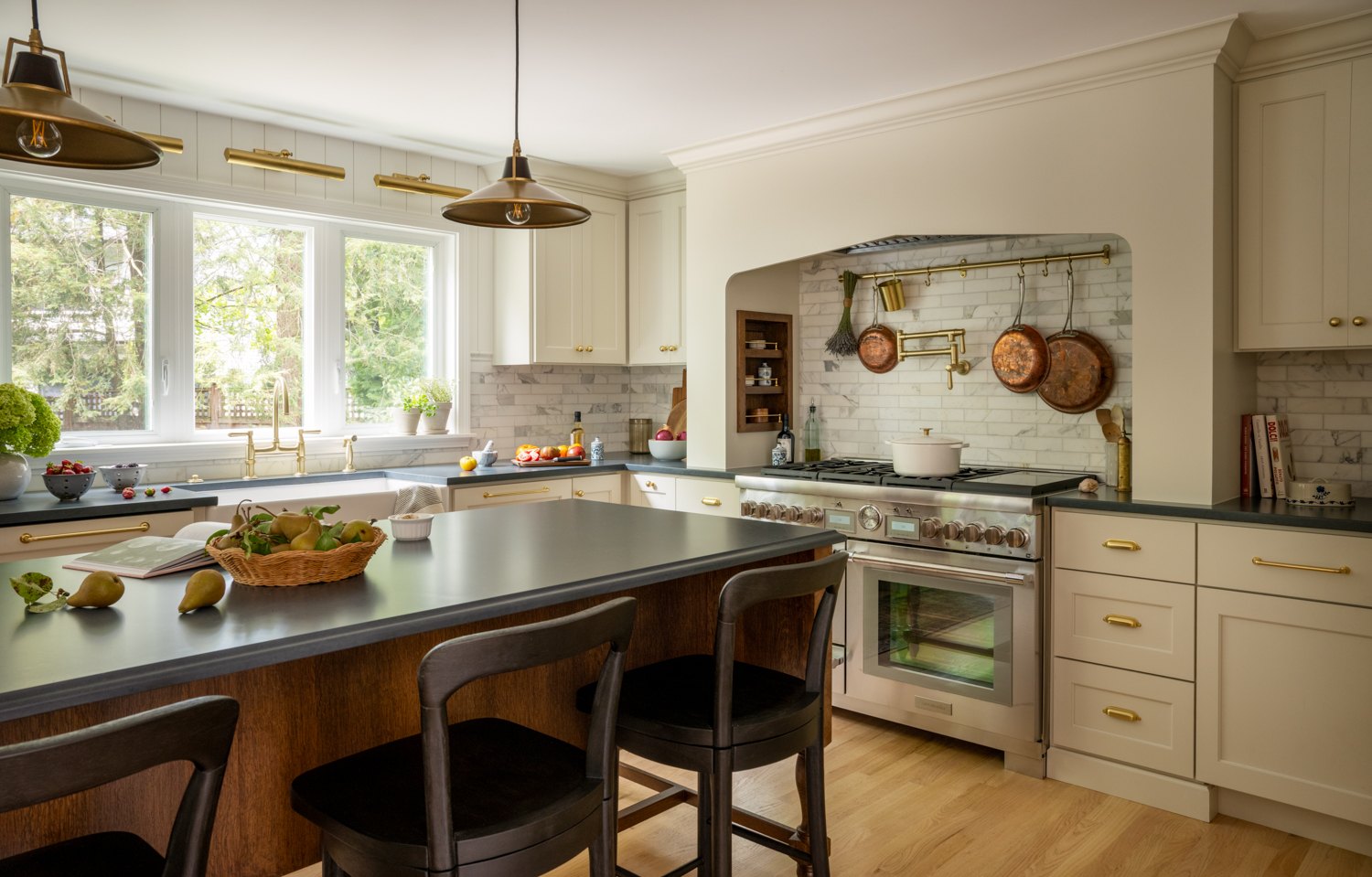 Range wall with a hanging rail above the cooktop, seen across the island