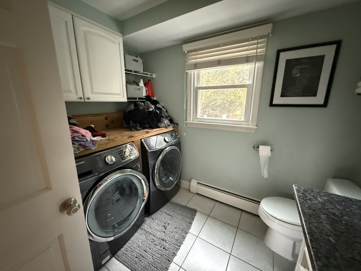 Washer and dryer installed in the original powder room at the center of the first floor
