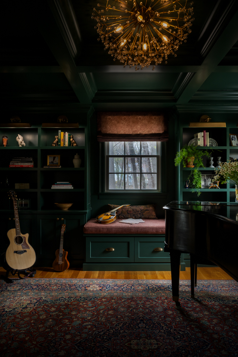 Green music room with built in shelving, a piano and a guitar