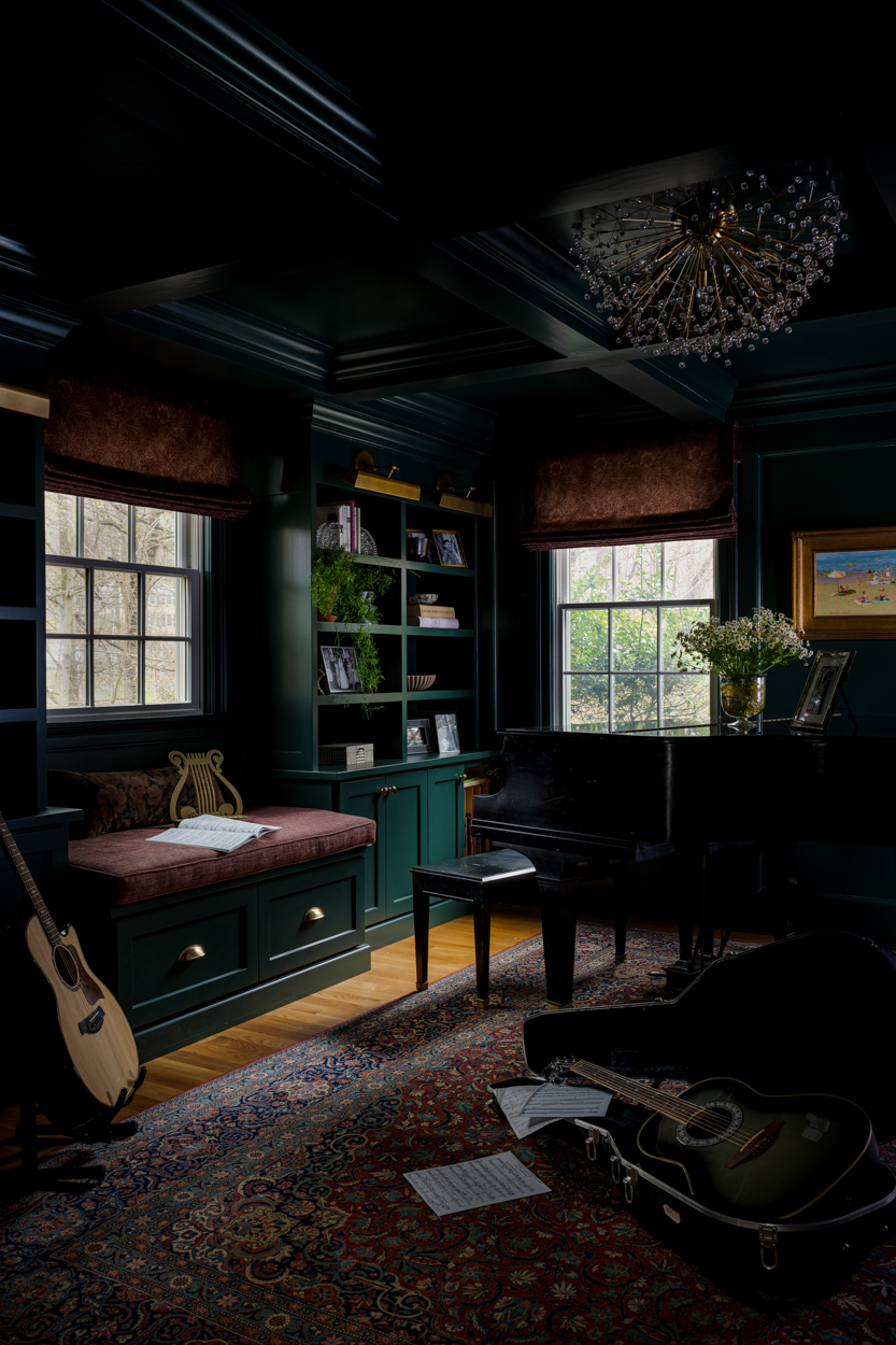 Music room with deep green panelled walls, a desk and instruments